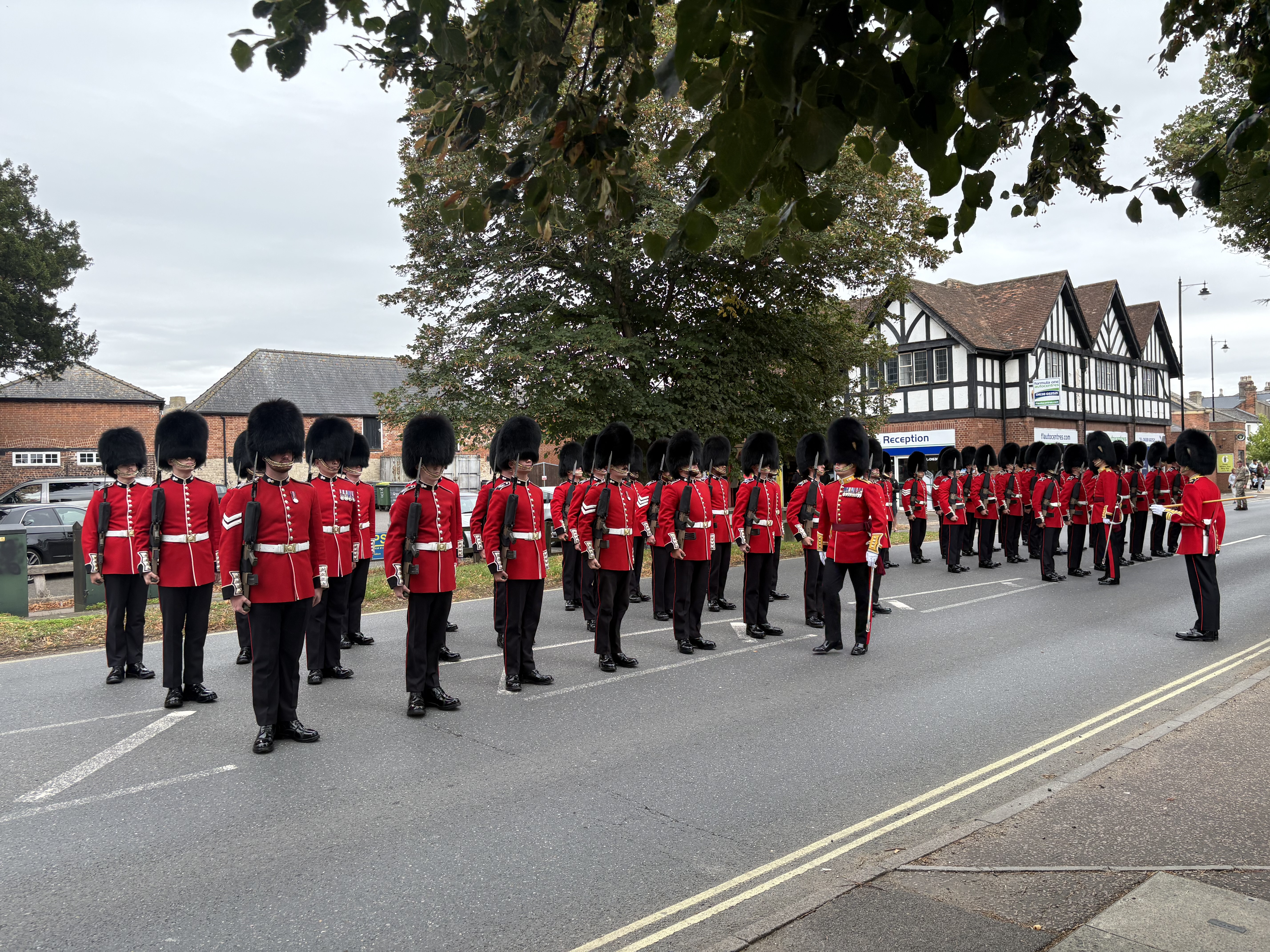 Guardsmen on parade in bearskins and scarlet tunics in Newmarket.