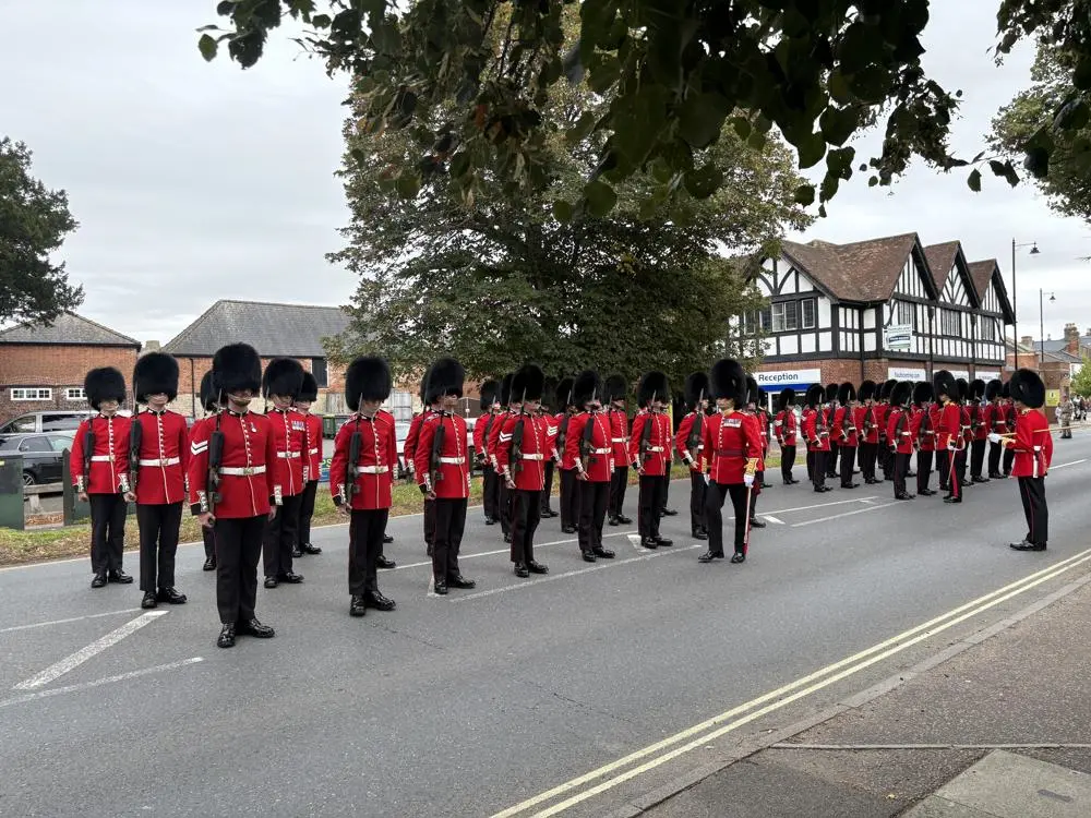Guardsmen on parade in bearskins and scarlet tunics in Newmarket.