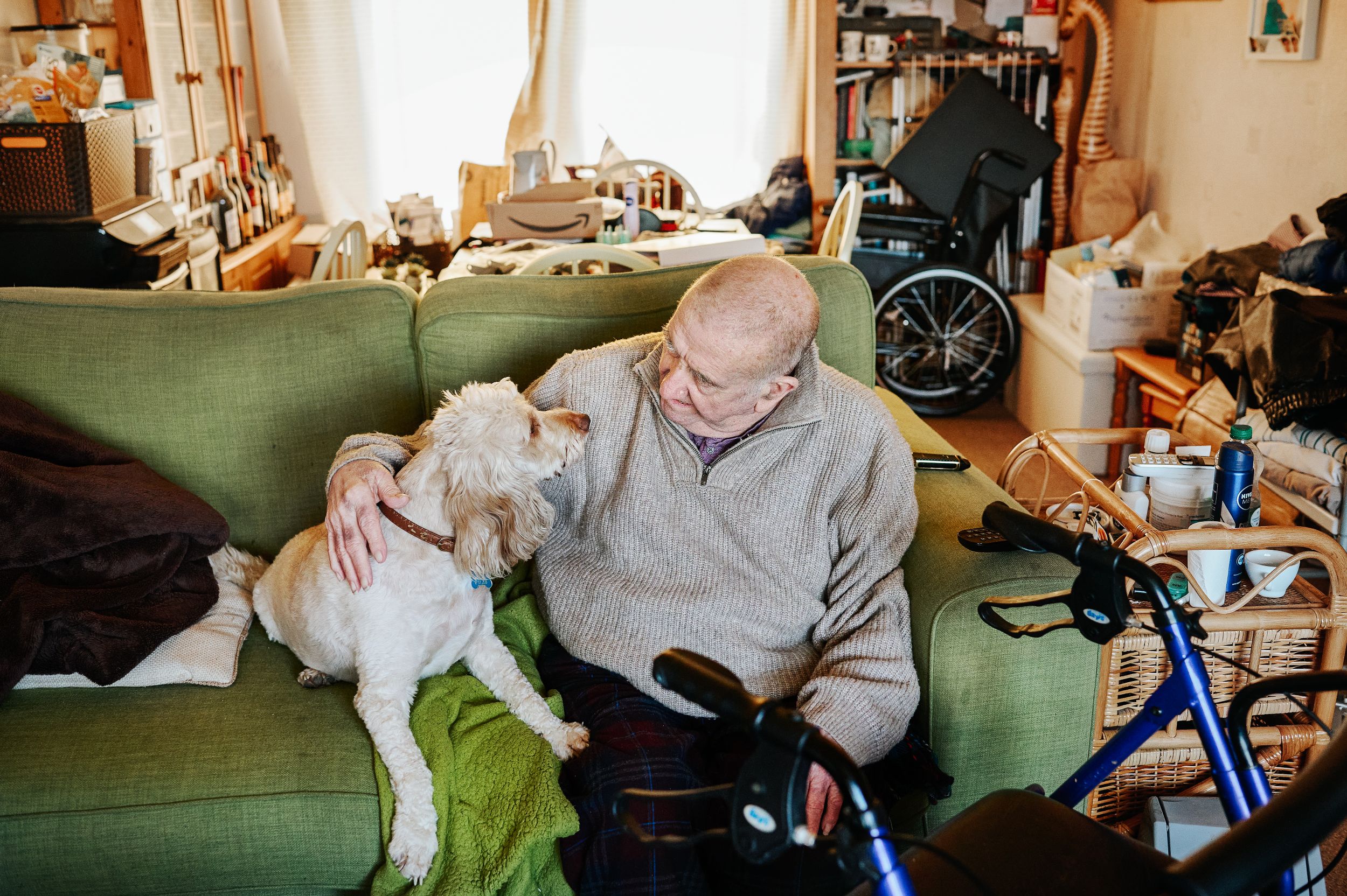 Man sitting on his sofa with his dog