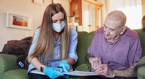 Man looking at a document with a care worker