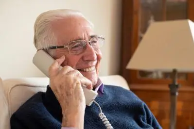 older man using home phone