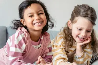 Two smiling children sitting together