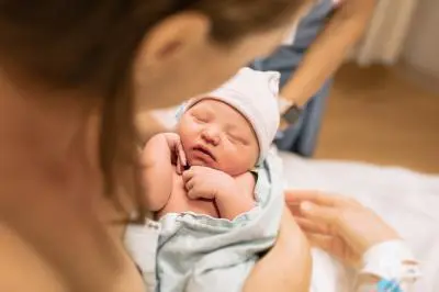 woman holding baby in her arms