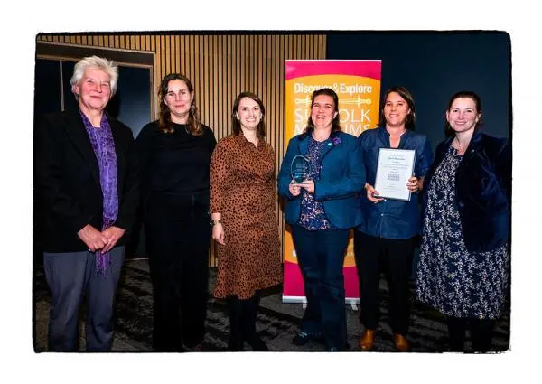 A group of people hold the Suffolk Museums Award