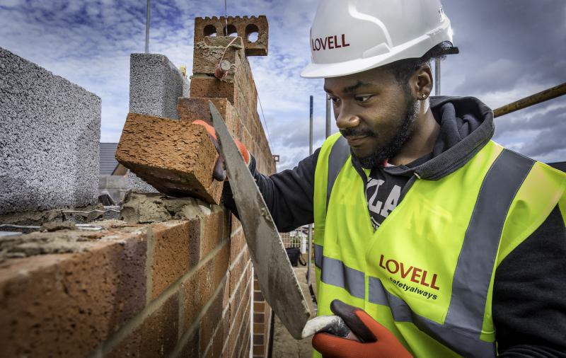 Making laying a brick on a wall. 