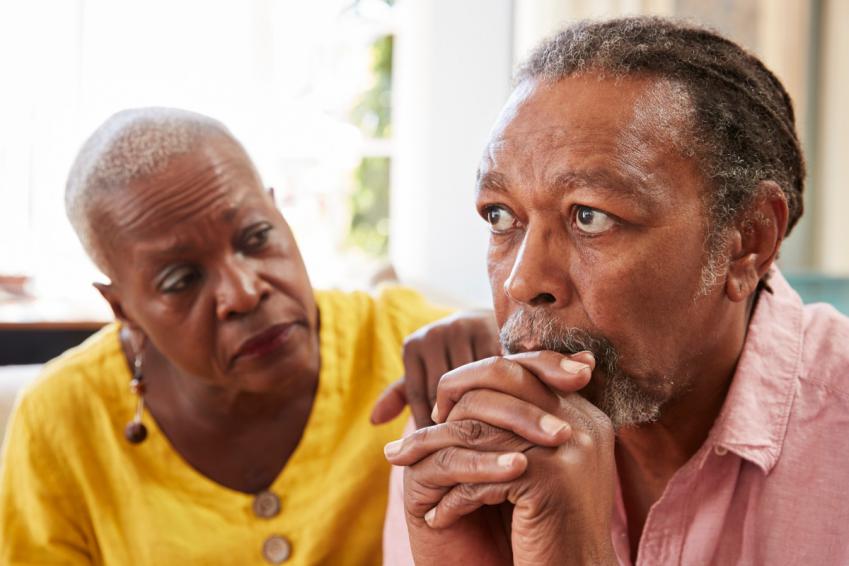 Older woman comforting older man