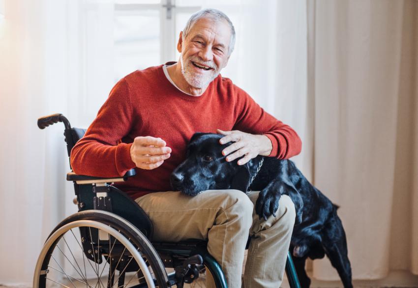 Wheelchair user at home with his dog