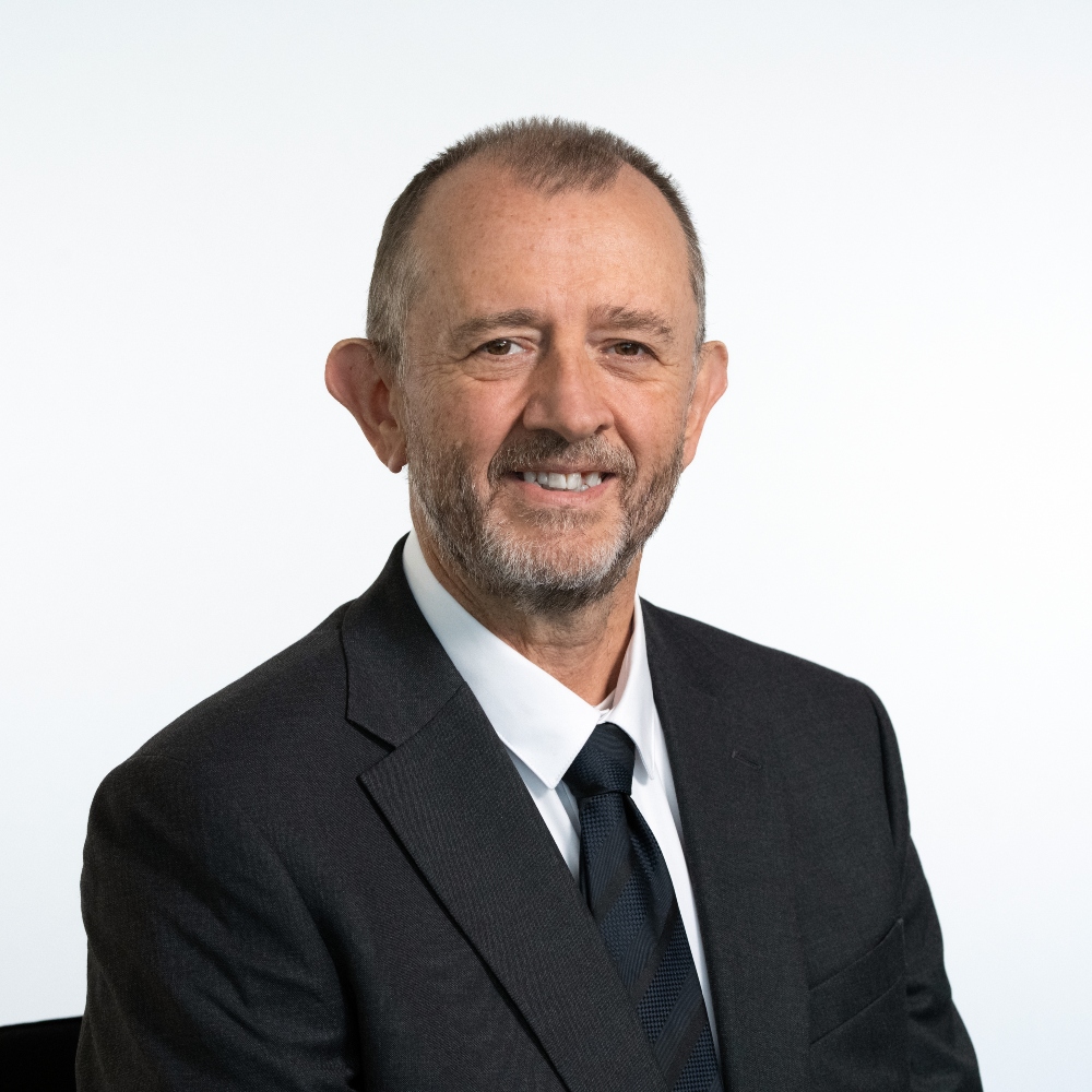 Cllr Joe Mason waring black suit, white shirt and tie