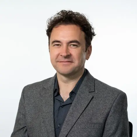Councillor Jonathan Ramsay wearing grey jacket and black shirt