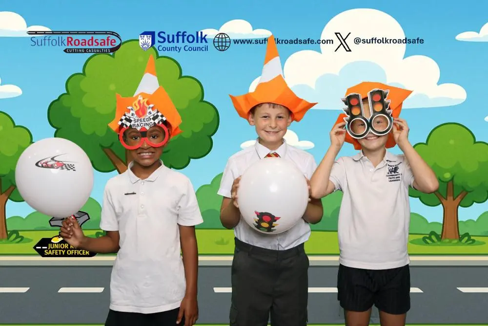 Three boys with traffic related head gear