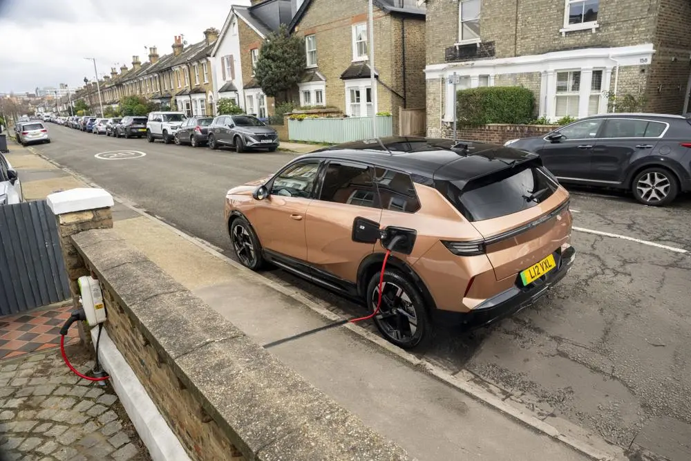 Electric or hybrid car being charged by a Kerbo-Charge point on a city street