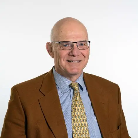 Cllr Martin Robinson wearing brown jacket, blue shirt and yellow tie