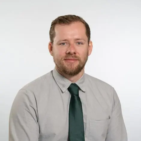 Councillor Matt Bentley wearing grey shirt and dark green tie