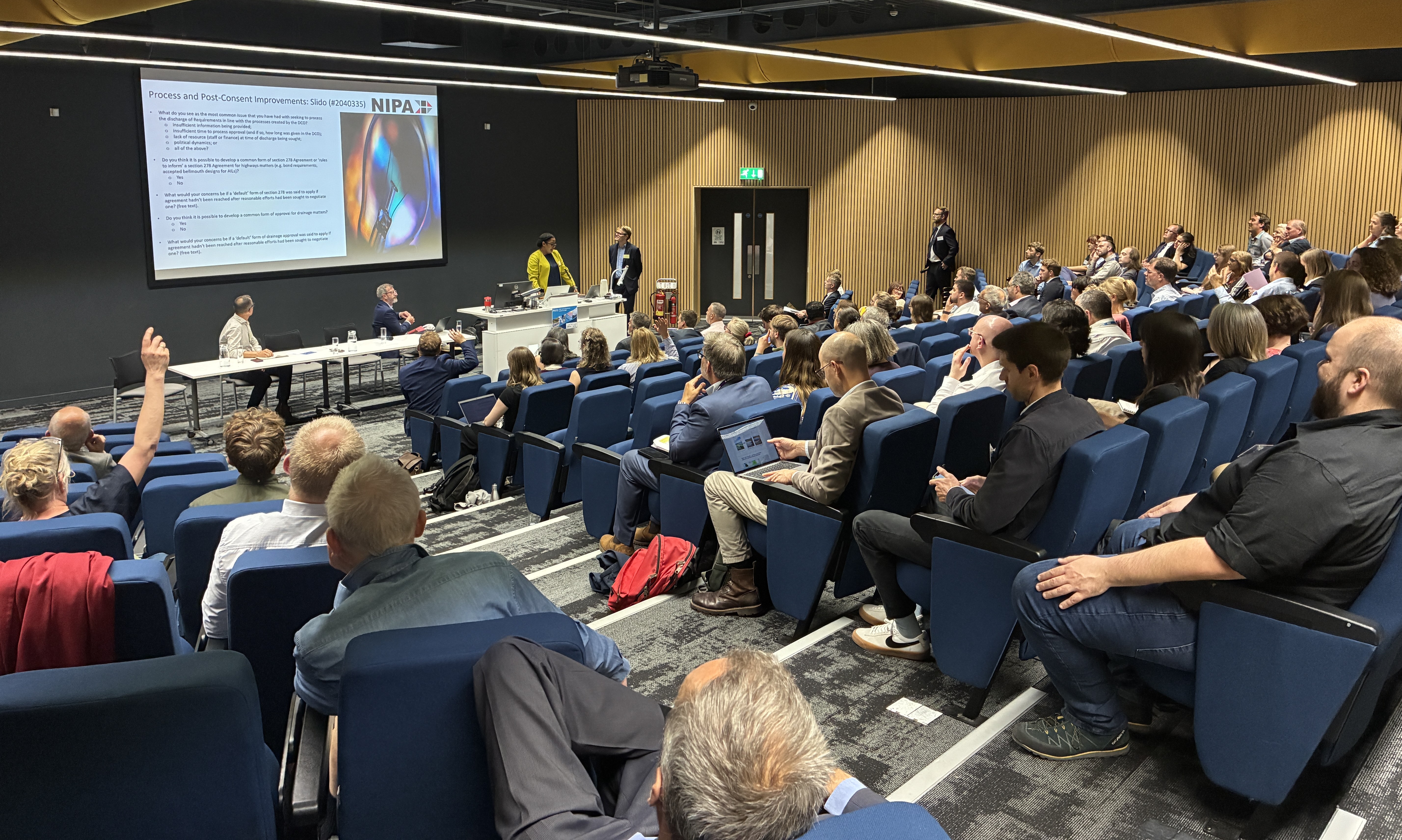 a lecture theatre full of delegates watching a presentation