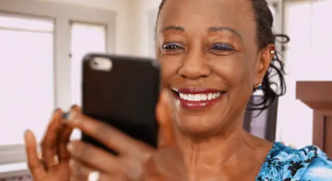 Older black woman using mobile phone