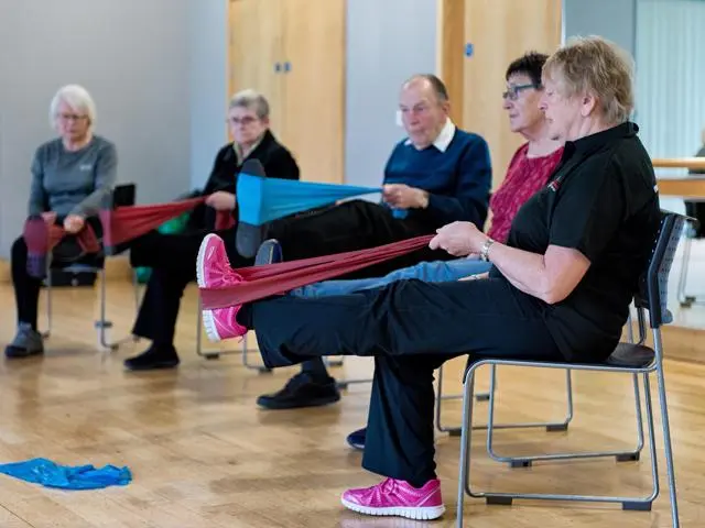 Older people doing stretching exercises to stay healthy 
