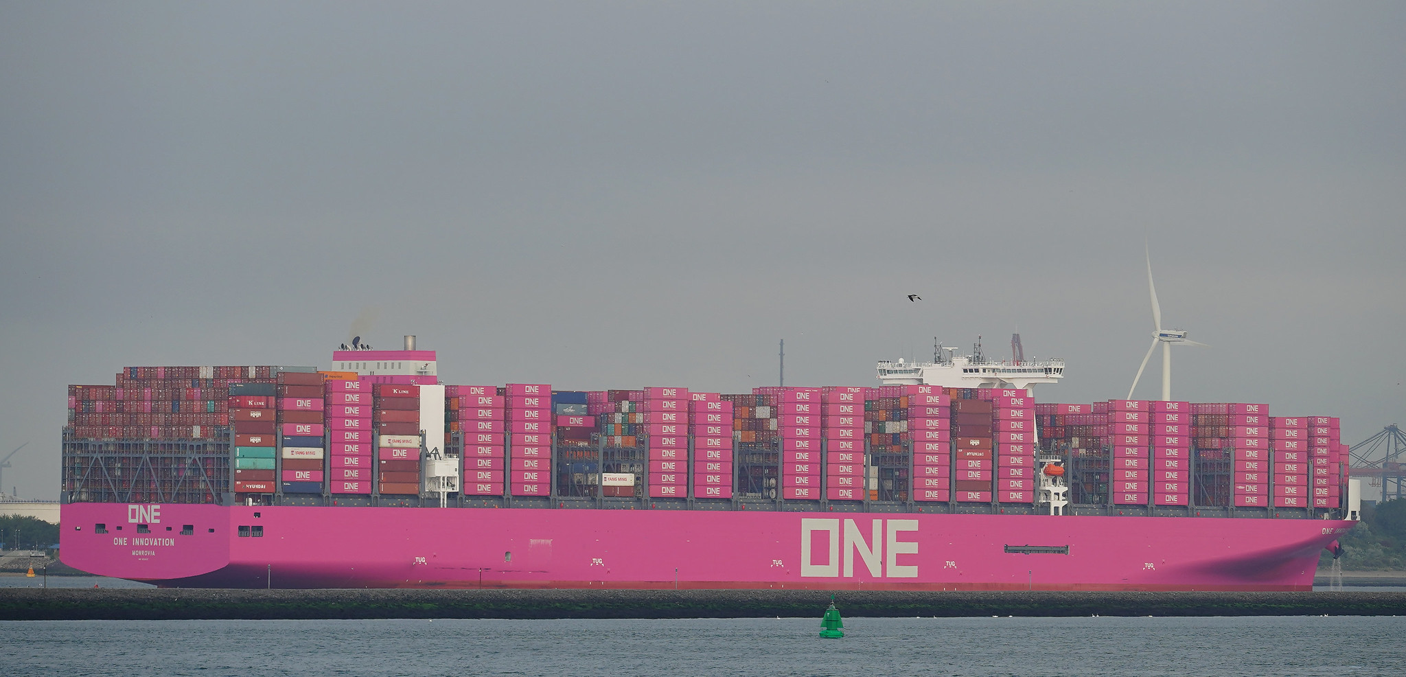 pink container ship arrives in port
