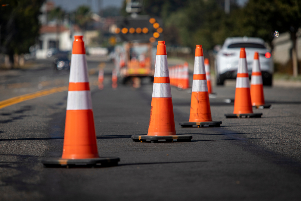 Orange traffic cones stand on a road