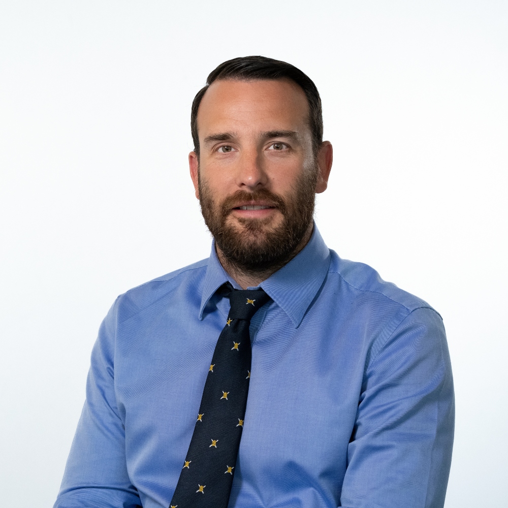 Councillor Paul Bains wearing blue shirt and black patterned tie