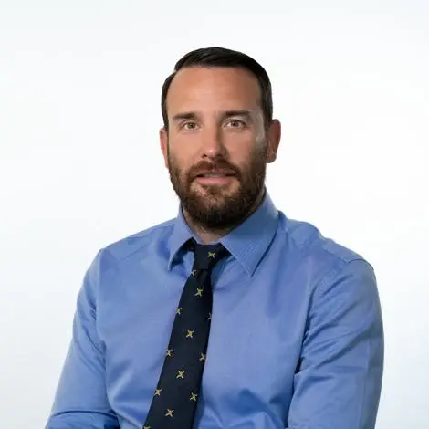 Councillor Paul Bains wearing blue shirt and black patterned tie
