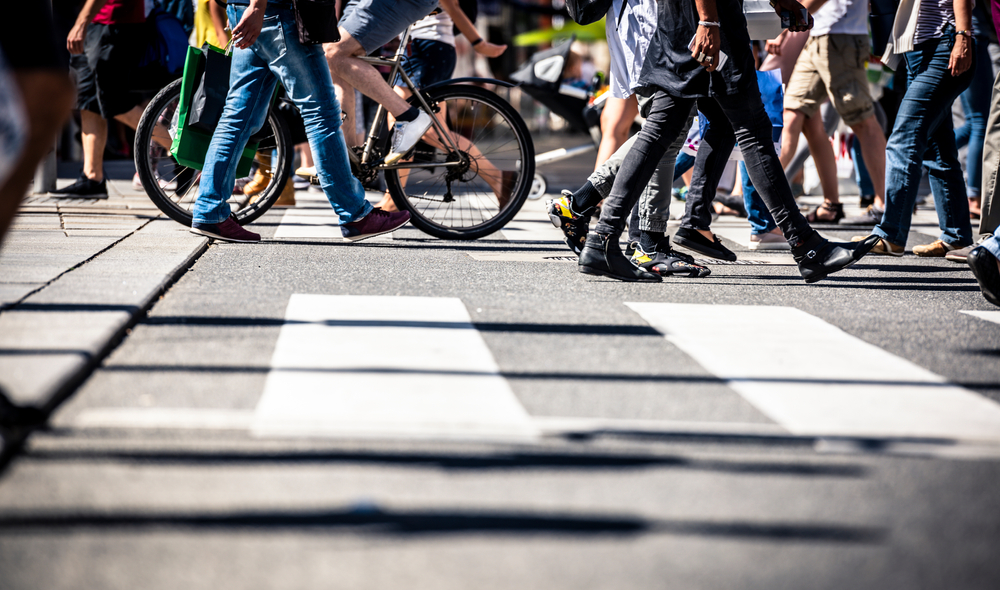 A group of people are walking across a zebra crossing