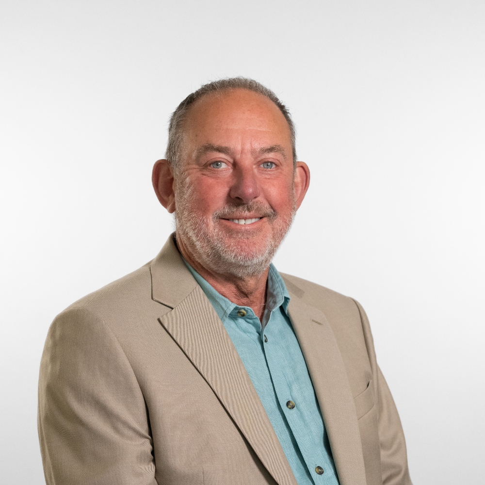 Councillor Peter Aiano wearing beige jacket and light green shirt