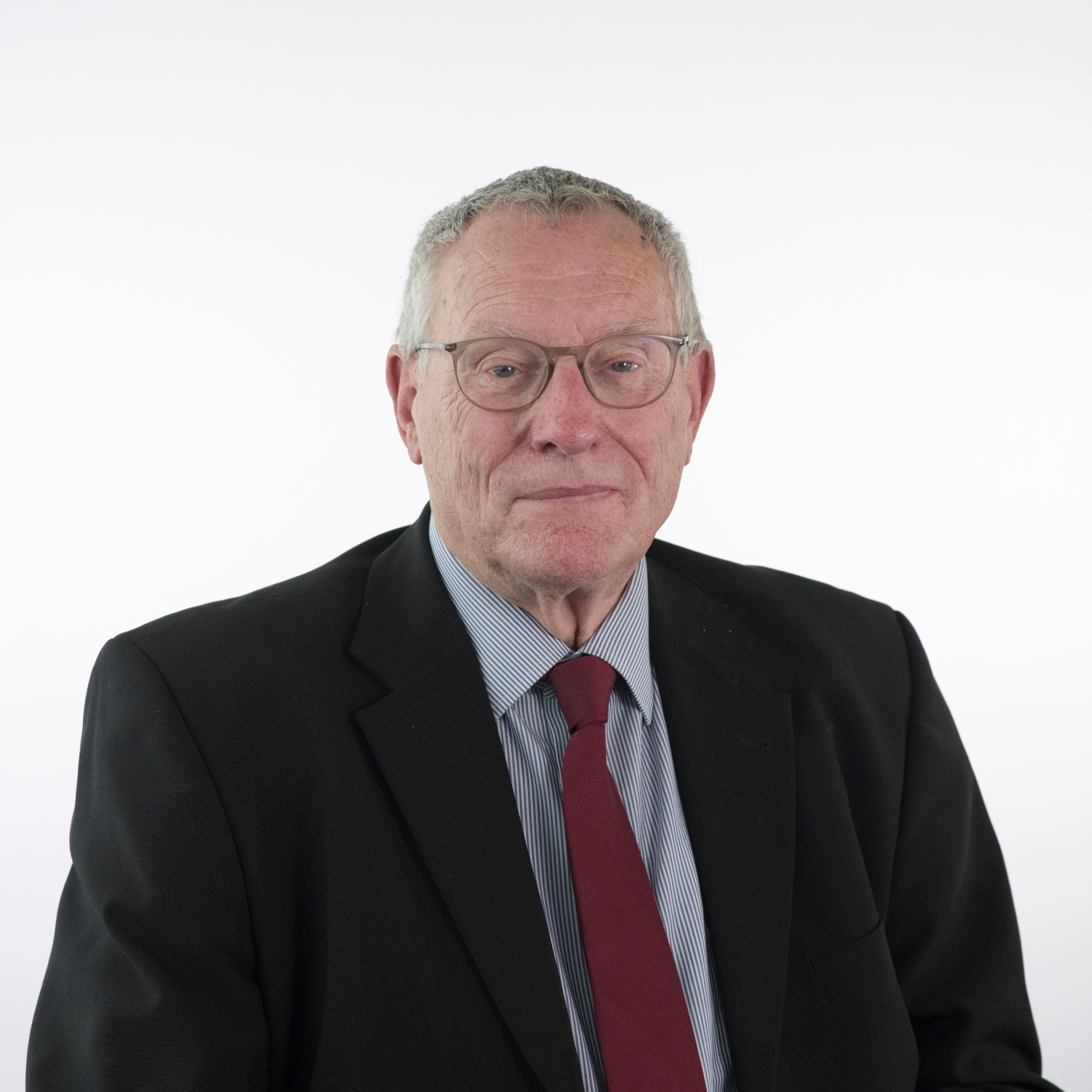 Cllr Peter Byatt wearing glasses and a red tie