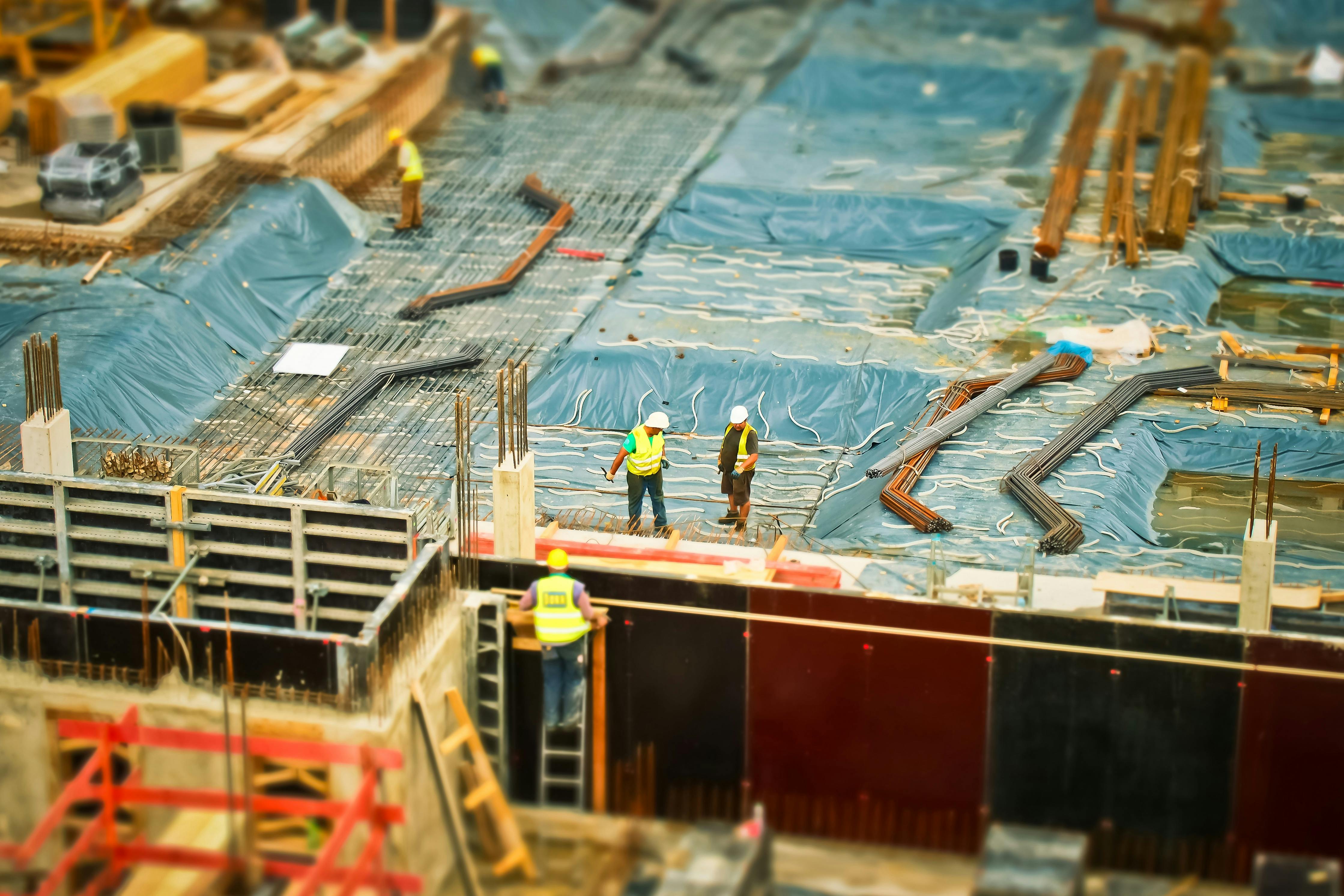 Construction workers on top of building in a work site