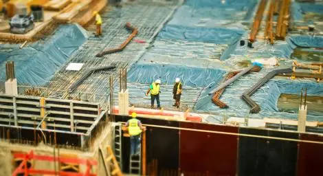 Construction workers on top of building in a work site