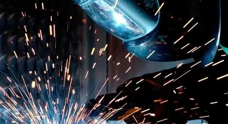 person in safety clothing carrying out welding