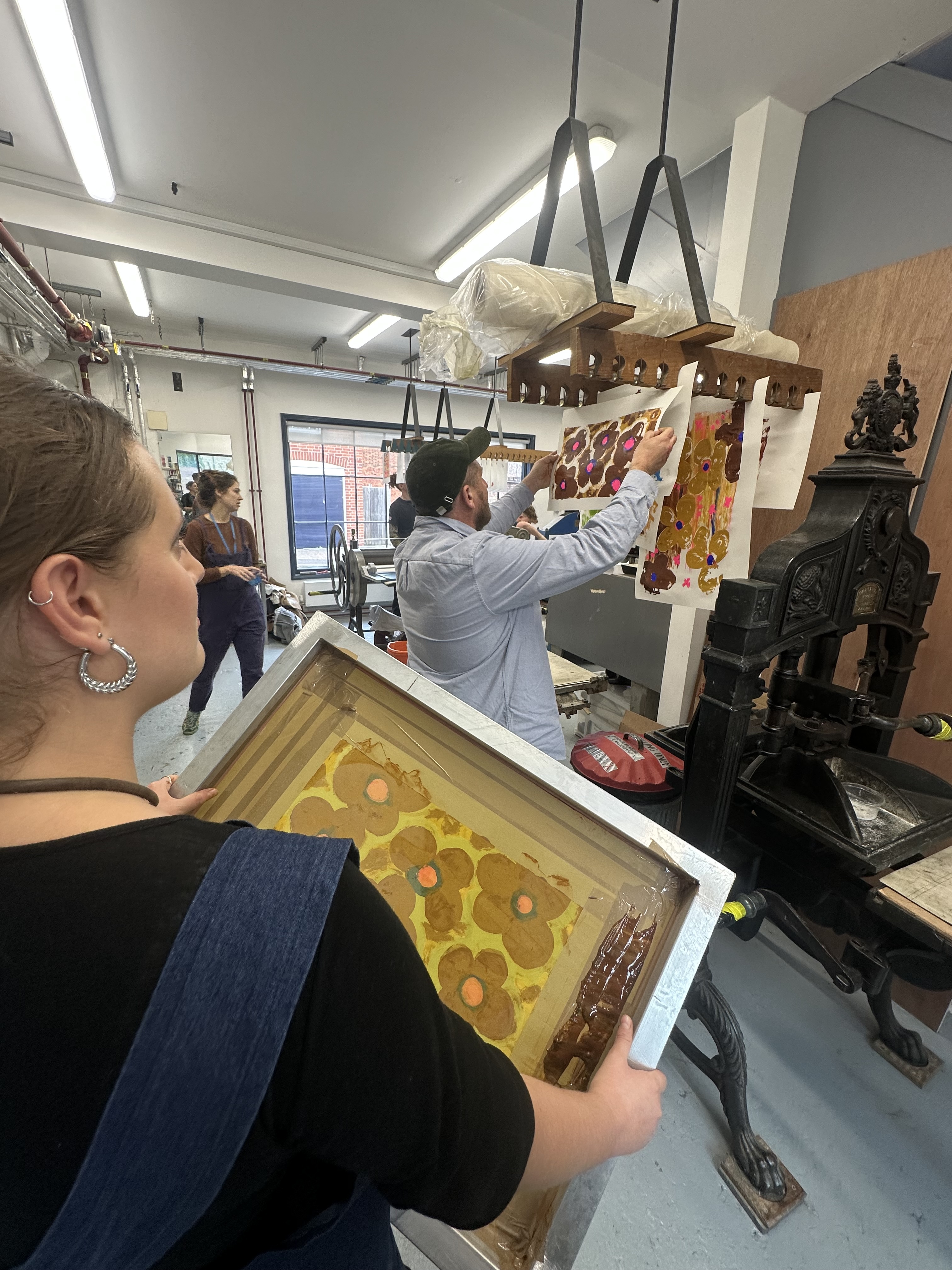 Young people hanging up their prints to dry