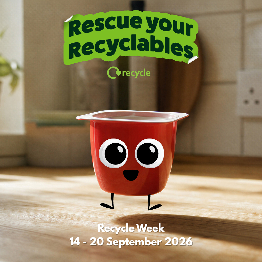 an animated red yogurt pot on a wooden surface