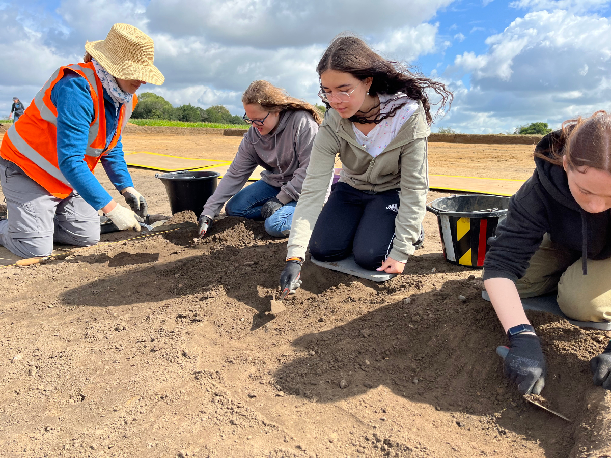 Volunteers excavating the remains of a ditch