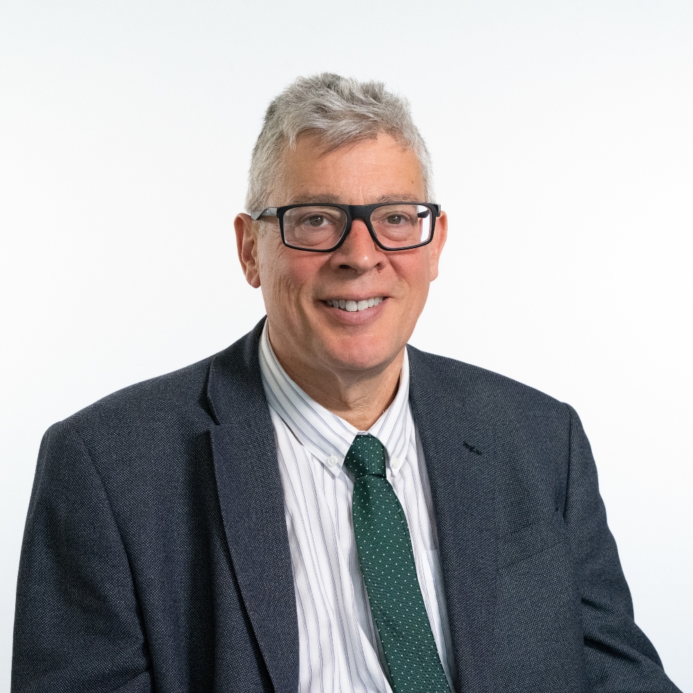 Councillor Robert Lindsay wearing grey jacket and green tie
