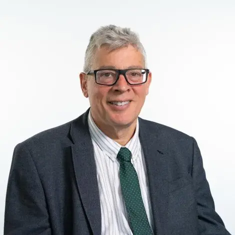 Councillor Robert Lindsay wearing grey jacket and green tie