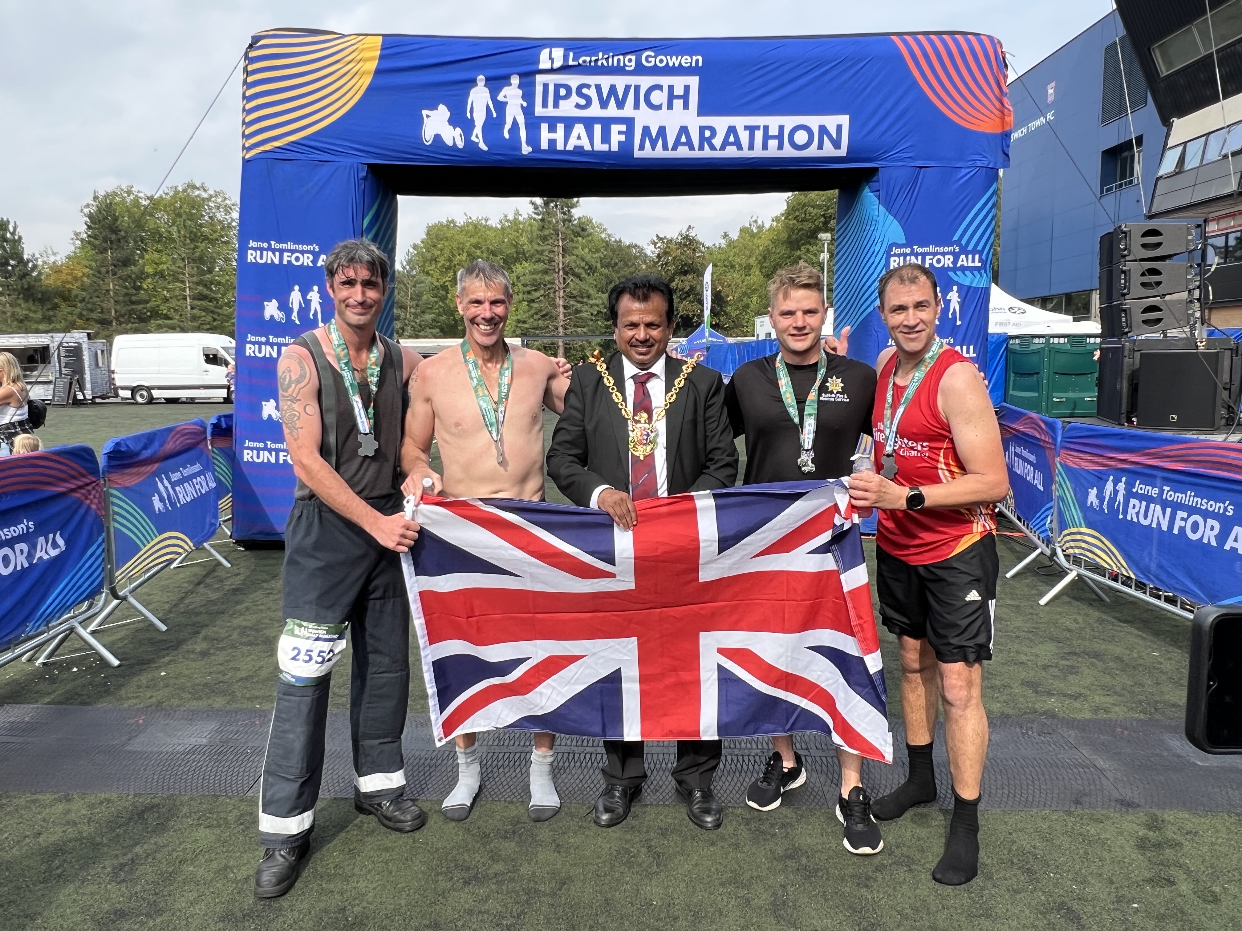 The four firefighters with the Mayor of Ipswich and holding a union flag.