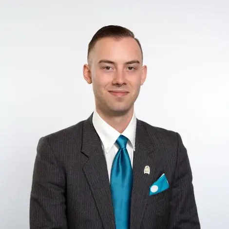 Councillor Ryan Procter wearing suit and tie