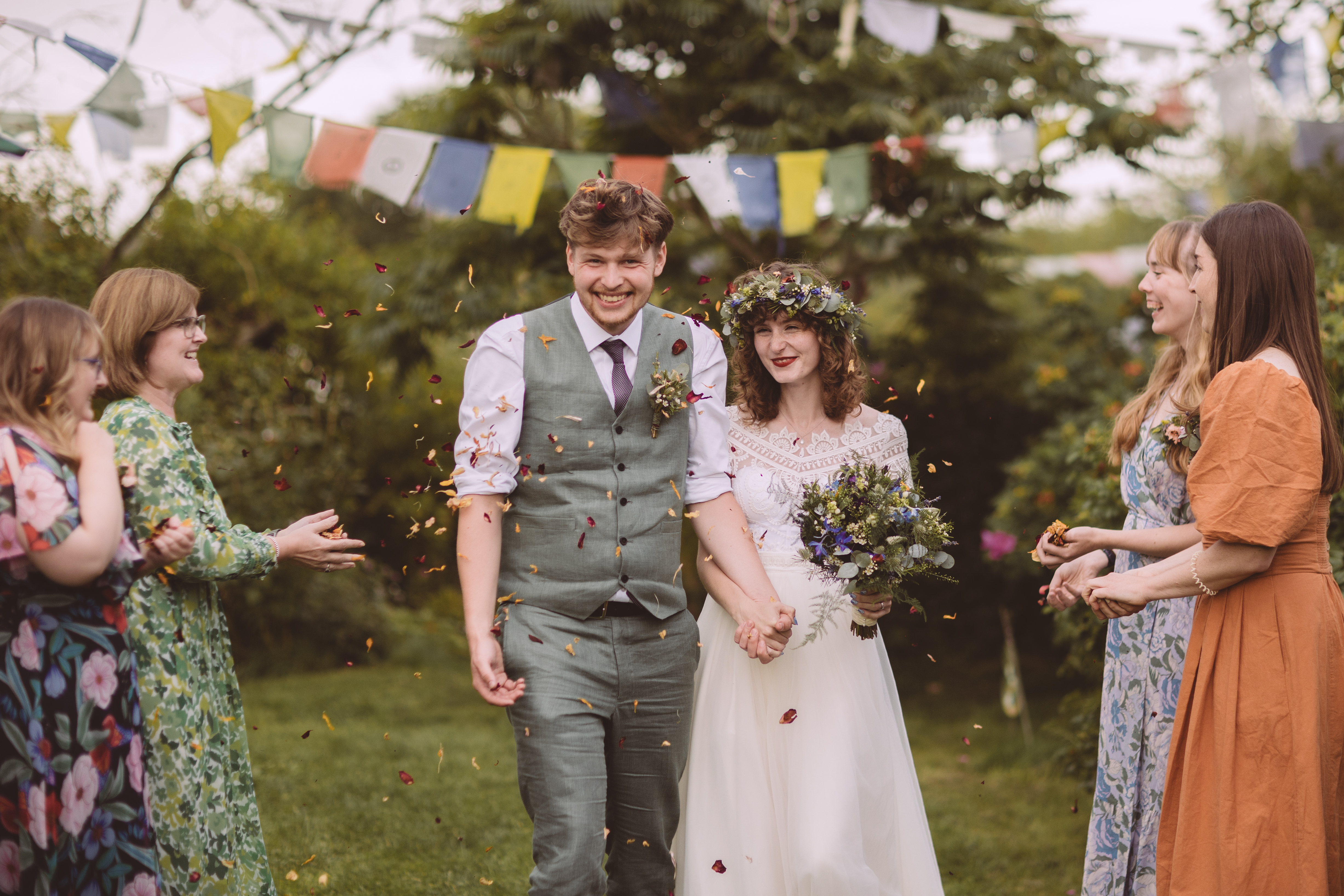 Bride and groom just married with confetti thrown at them.