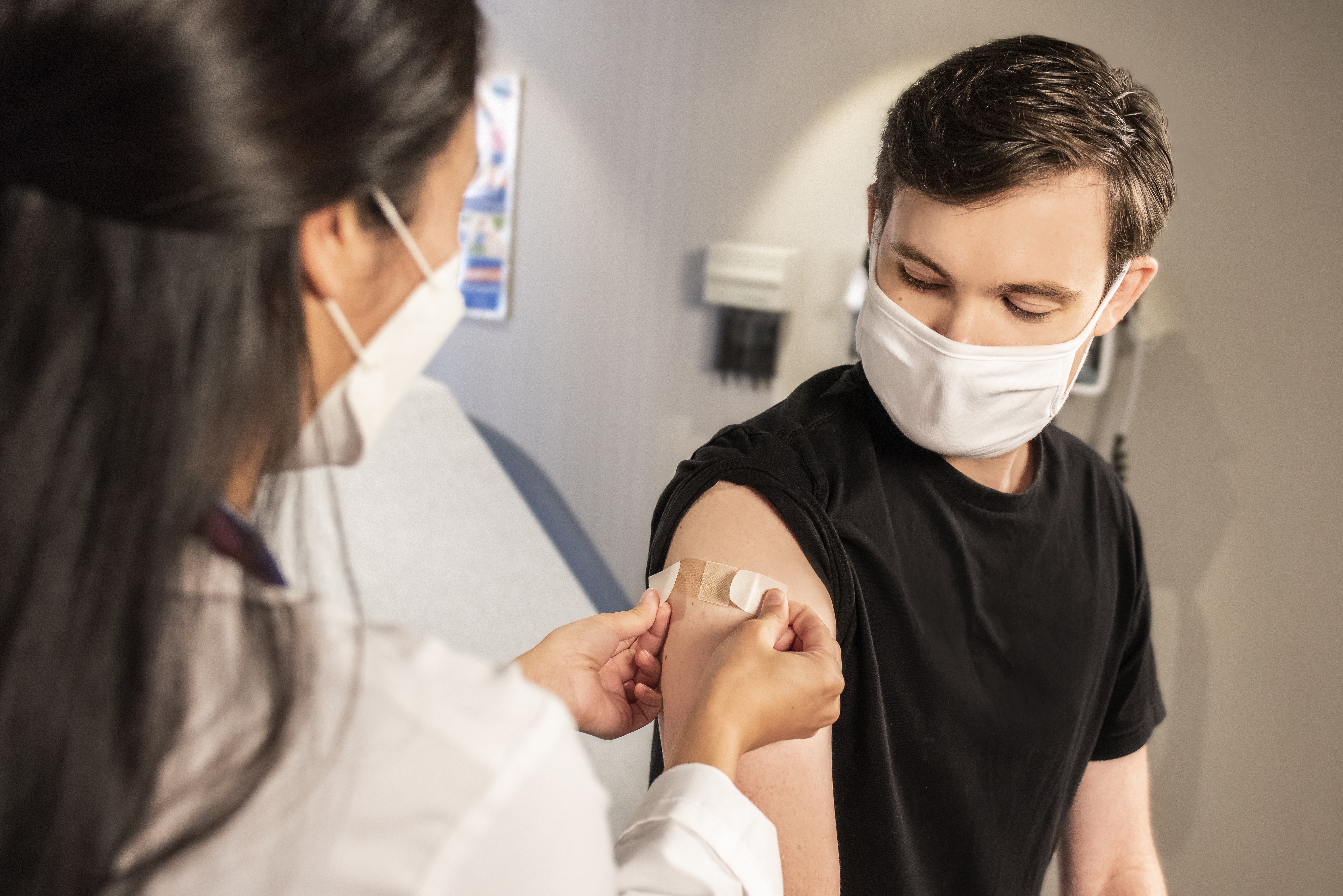 School nurse giving injection to a student