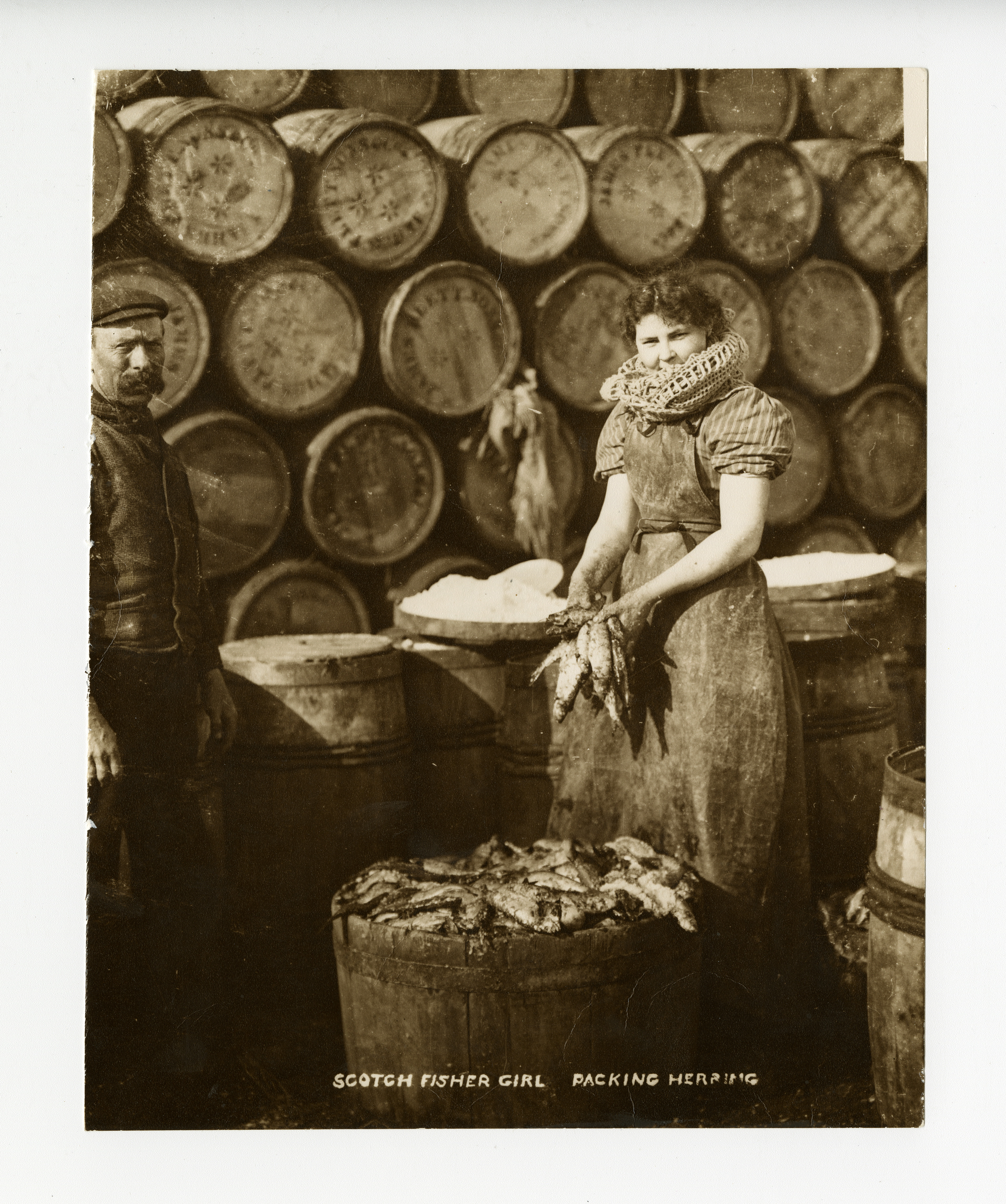 One of the Scotch Girls, as they were known south of the border, packing herring. 