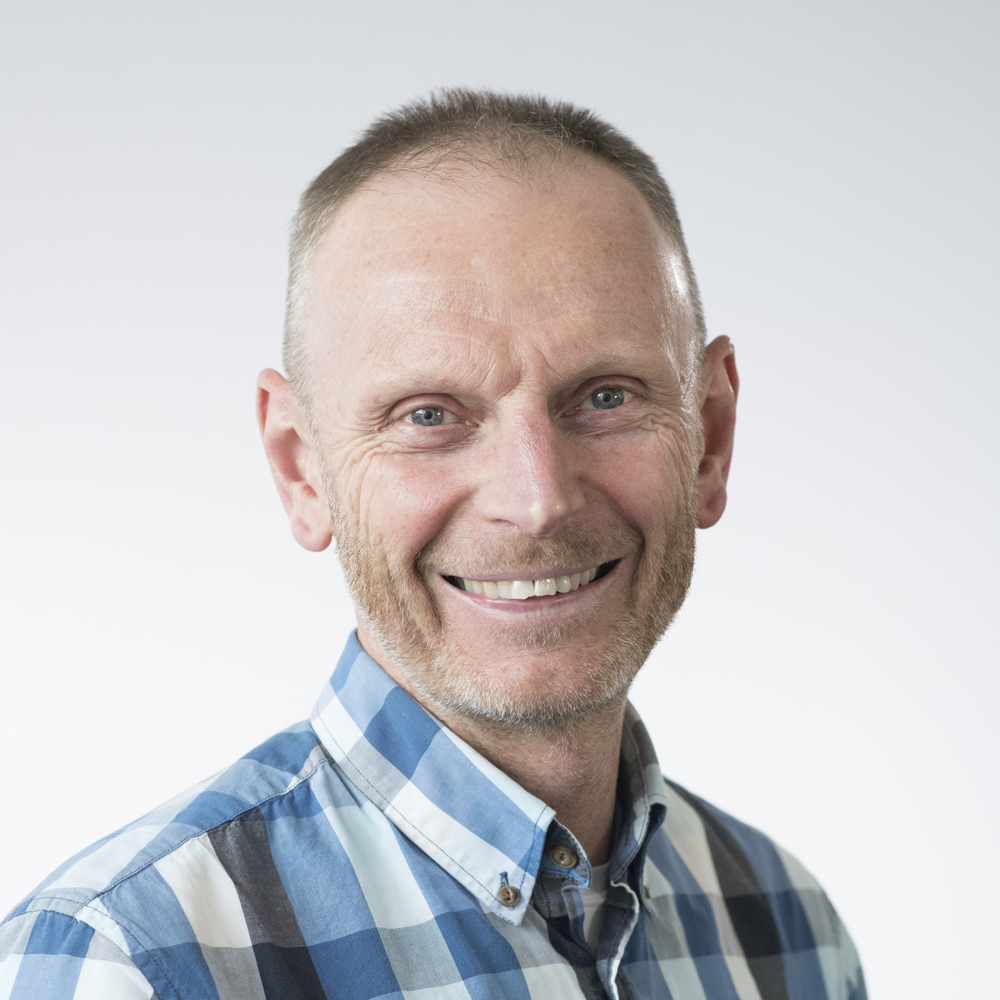 Seamus Bennett in blue, grey and white shirt. 