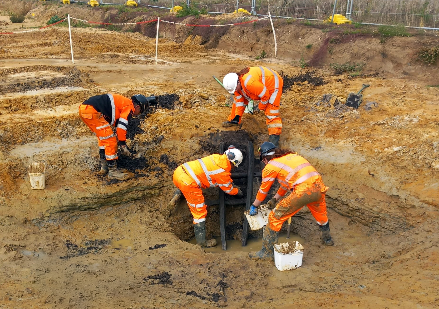An Iron Age ladder, placed in a well, being carefully exposed and recovered by the OCA team