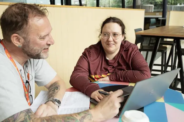 Two people discussing options in a cafe.