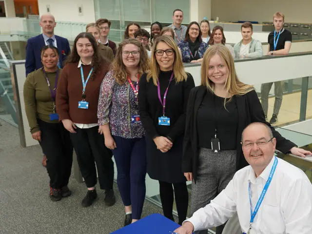 Various staff at Suffolk County Council smiling at Endeavour House in Ipswich