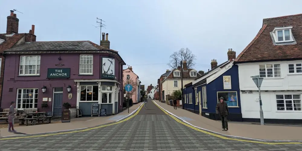 The Anchor pub on the junction of Station Road and Quay Street with people walking across a new road with