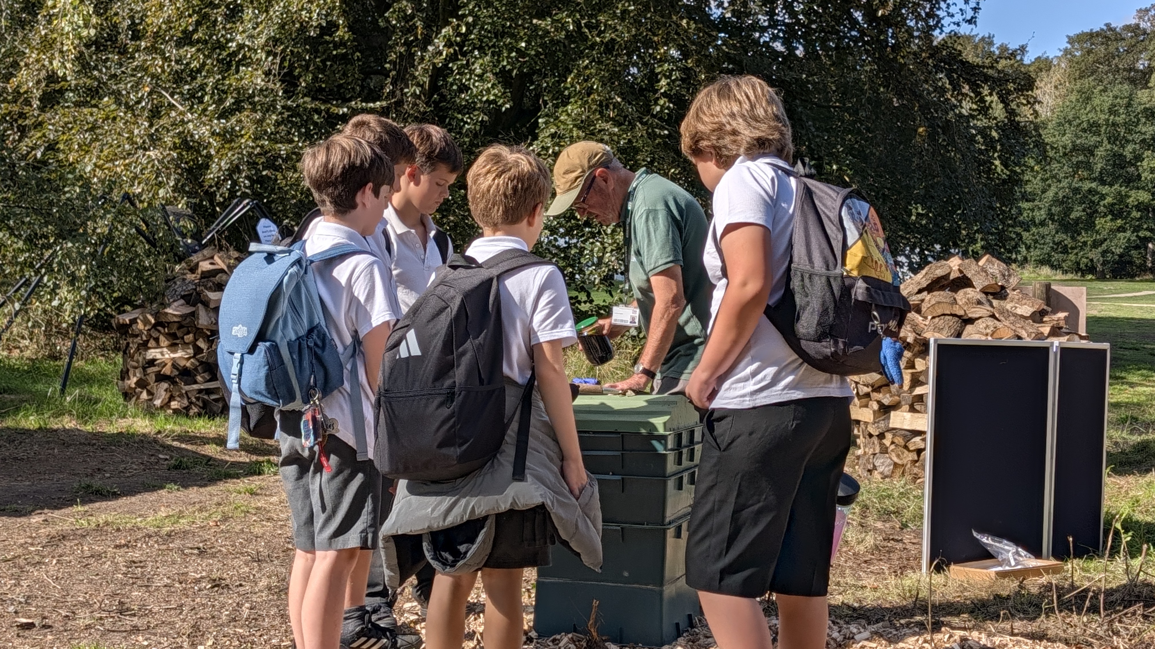 school pupils learn about composting from an expert