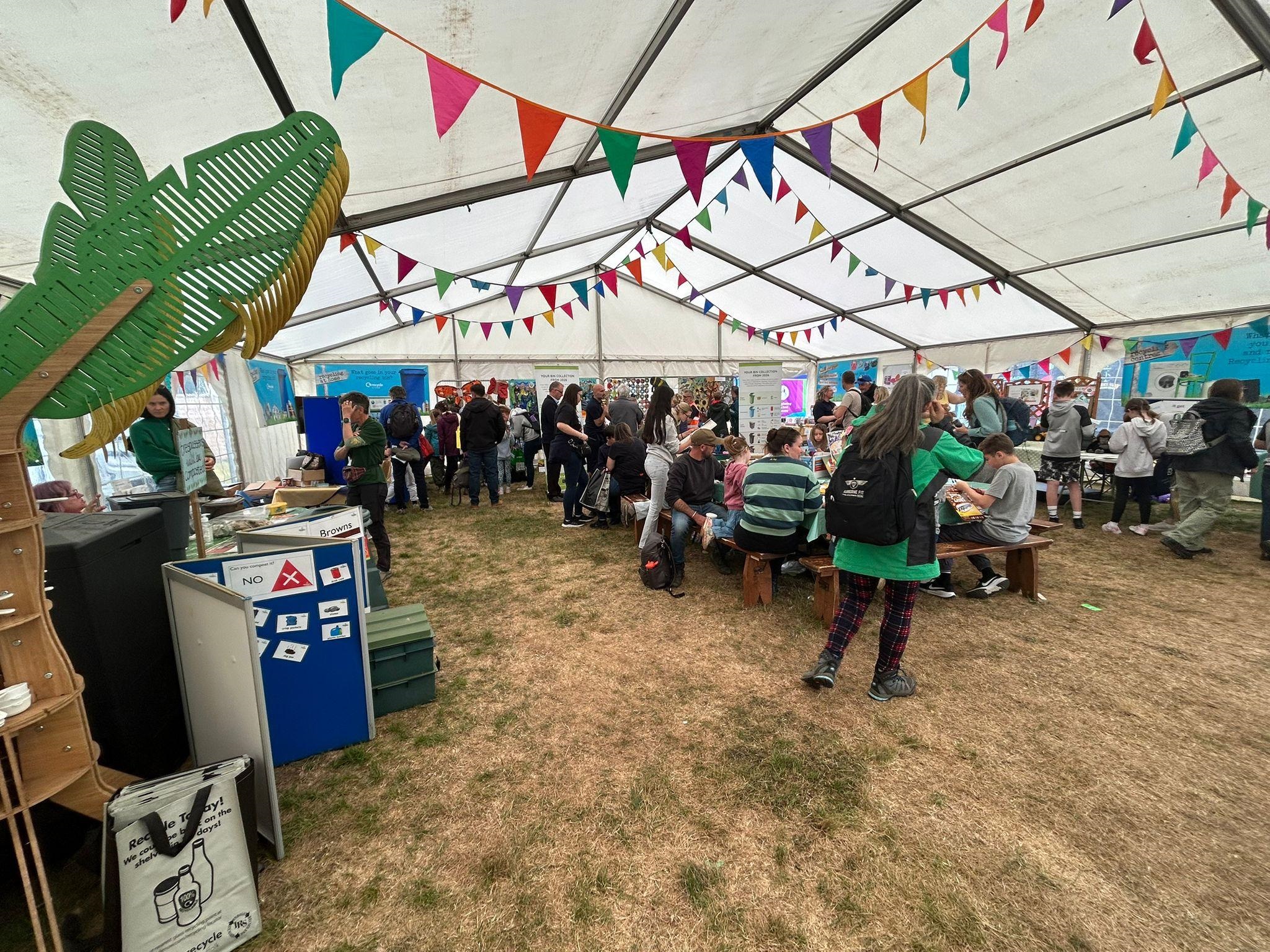 inside the tent with display stands and children doing crafting activities