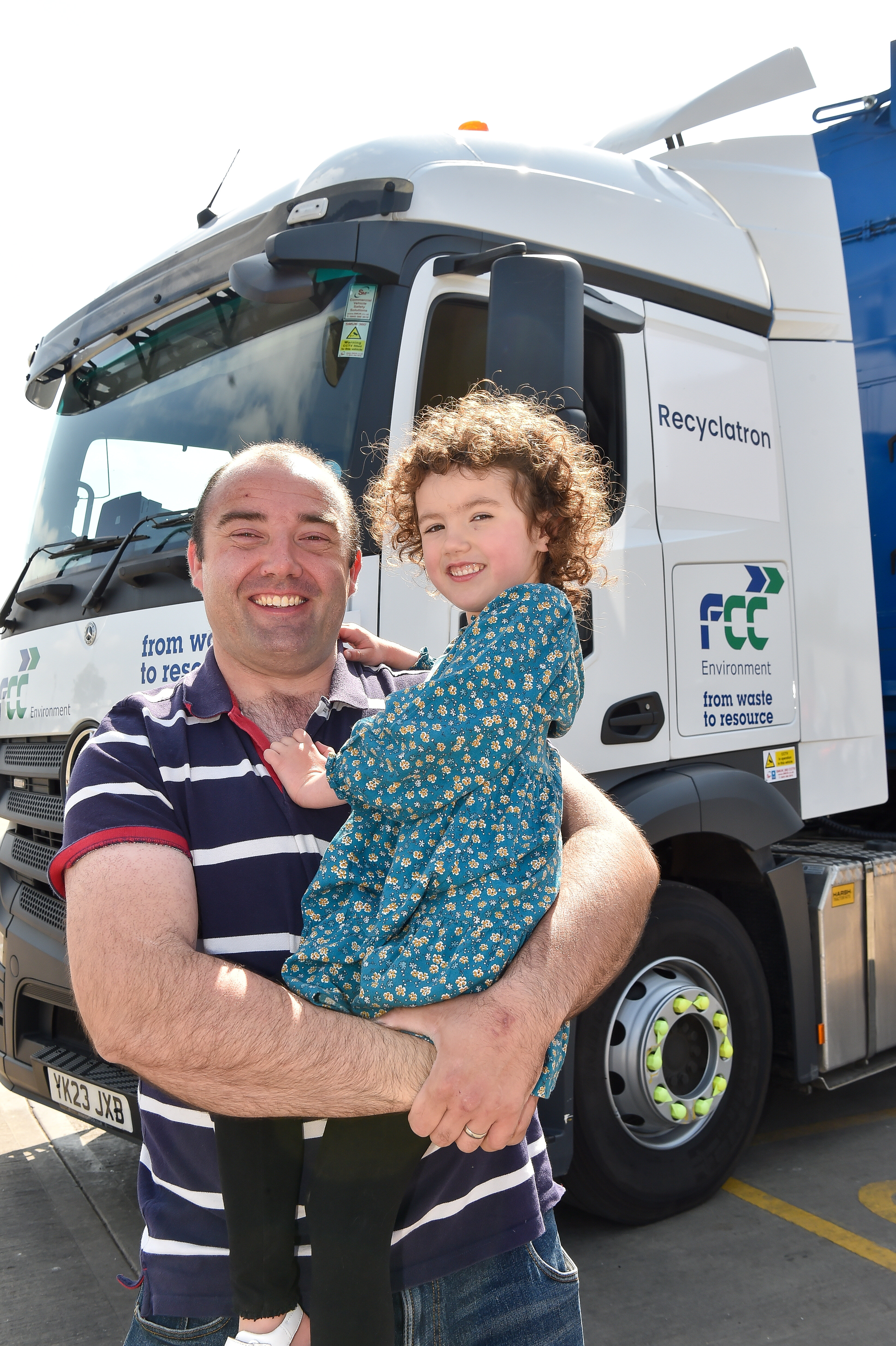 Milly with dad Scott Edgar in front of the lorry Recyclatron. (Picture: SWNS)