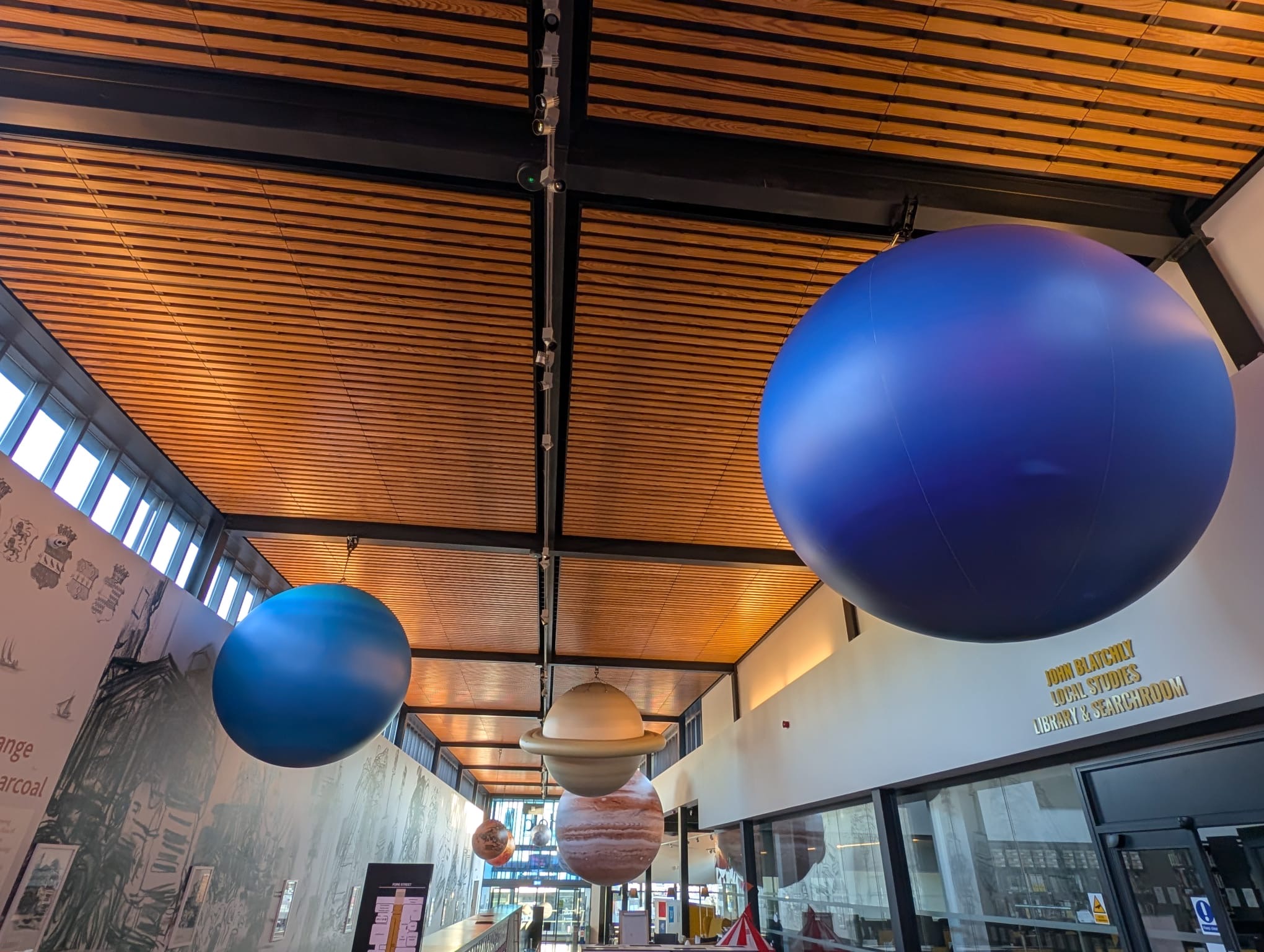 A solar system installation suspended from the ceiling of The Hold in Ipswich