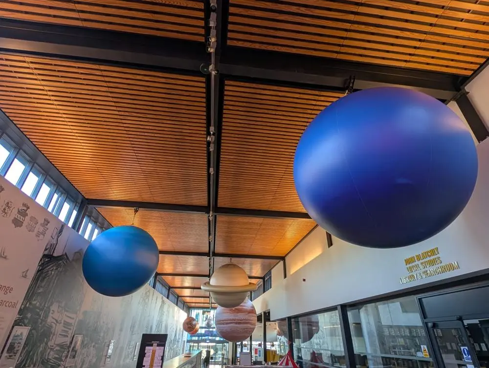 A solar system installation suspended from the ceiling of The Hold in Ipswich